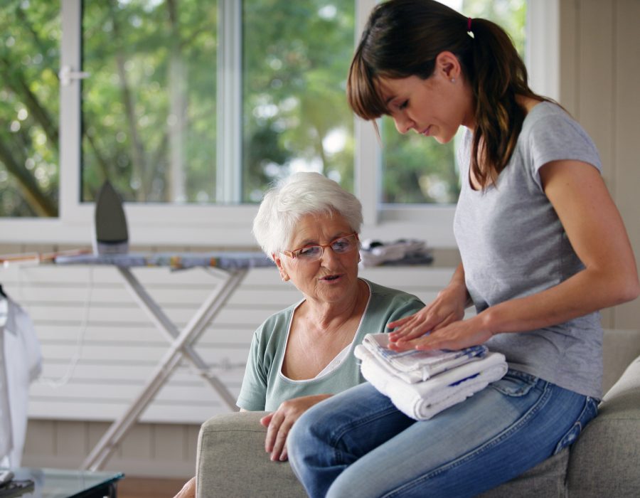 young woman helping senior lady with the housework